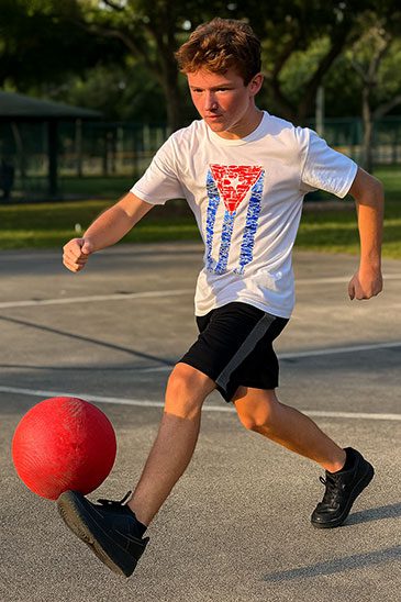 Miami-Boy-playing-kickball-wearing-the-Cuban-Flag-from-Fishes-tshirt-by-Made-In-Dade