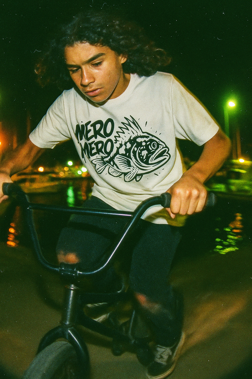 14 year old boy on bike wearing the mero mero tshirt by made in dade