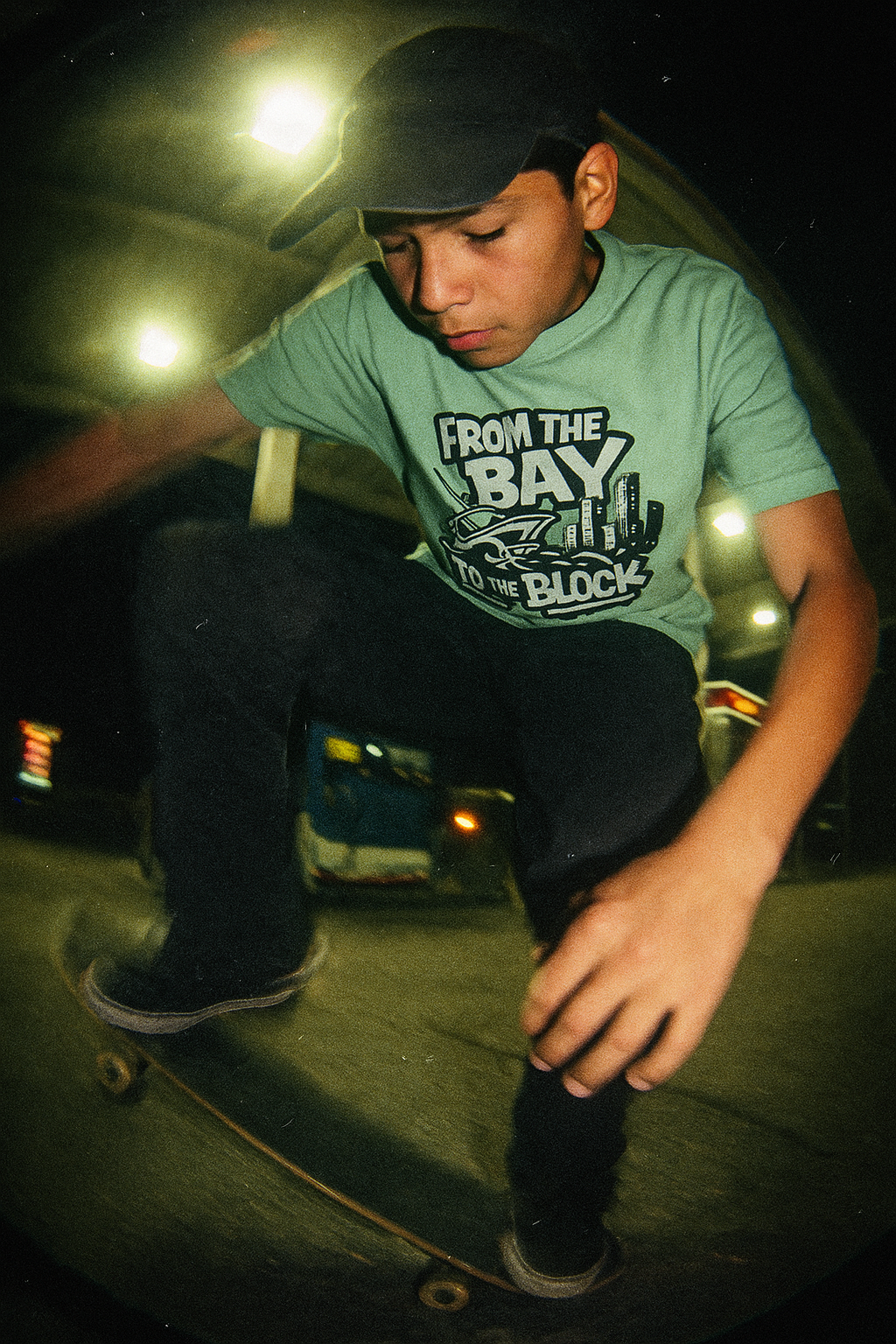 14 year old boy on skate board wearing the bay to the block tshirt by made in dade 2