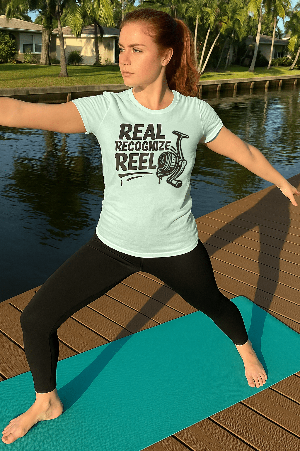 red head woman doing yoga pose wearing Real Recognize Reel tshirt by Made In Dade